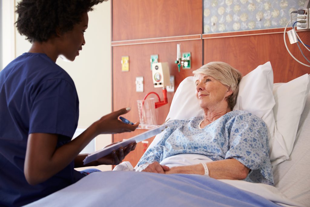 "361341143-huge.jpg by Monkey Business Images is used under license from Shutterstock.com Image showing a nurse speaking with an elderly patient who is sitting up in a hospital bed